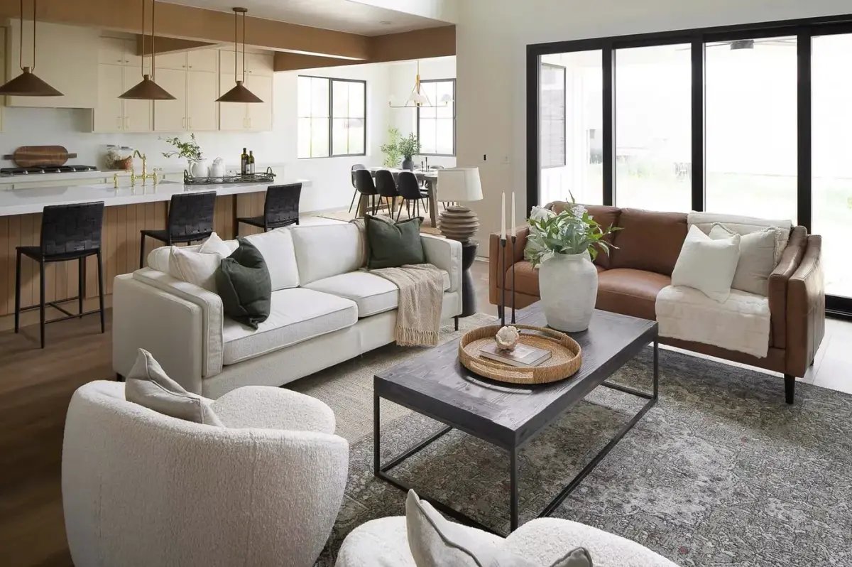 Living room open to the kitchen and dining table, large windows to the yard