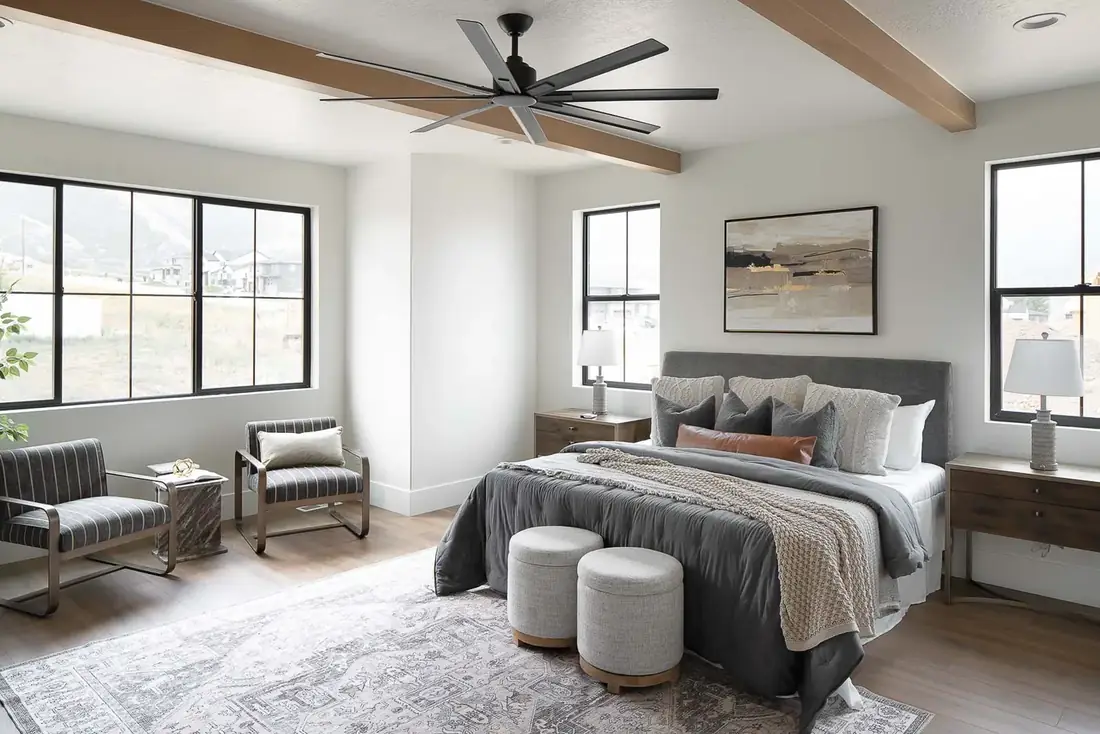 Bedroom with exposed beams and large windows